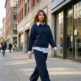 Navy collared sweatshirt set worn walking, with the shirt tail showing below
