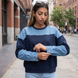 Navy sweatshirt with a light denim yoke and denim sleeves with silver snap cuffs