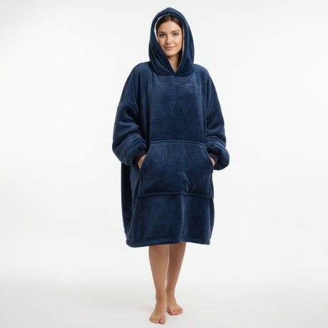 Person wearing a navy blue hooddedblanket with pockets on a white background