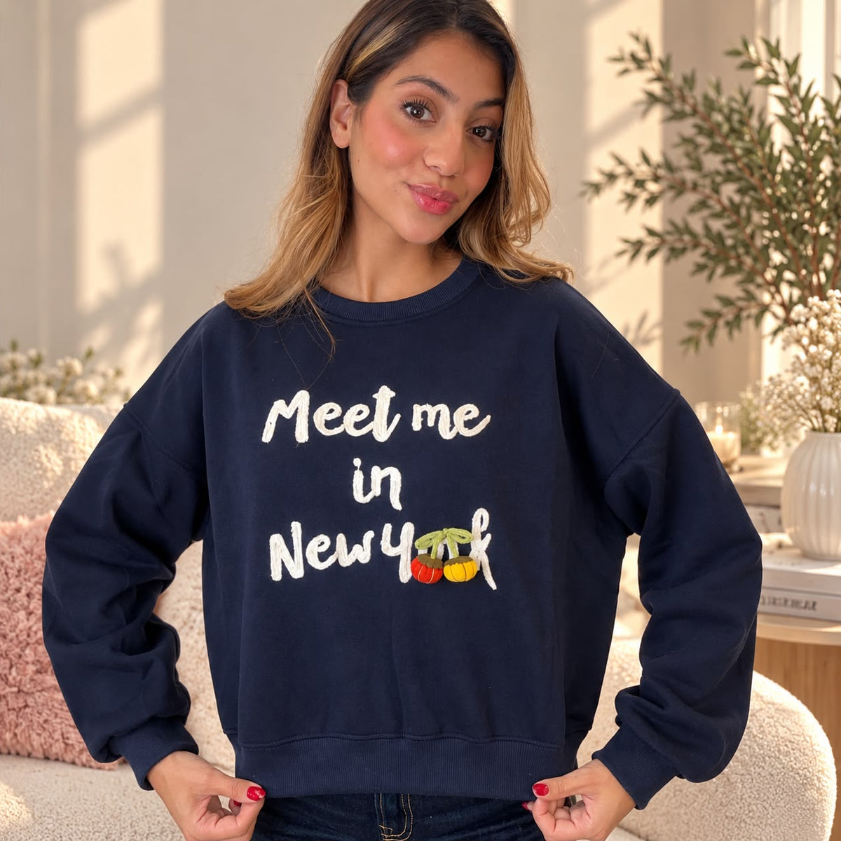 Front view of the navy sweatshirt with cream script lettering and red and yellow cherry charms