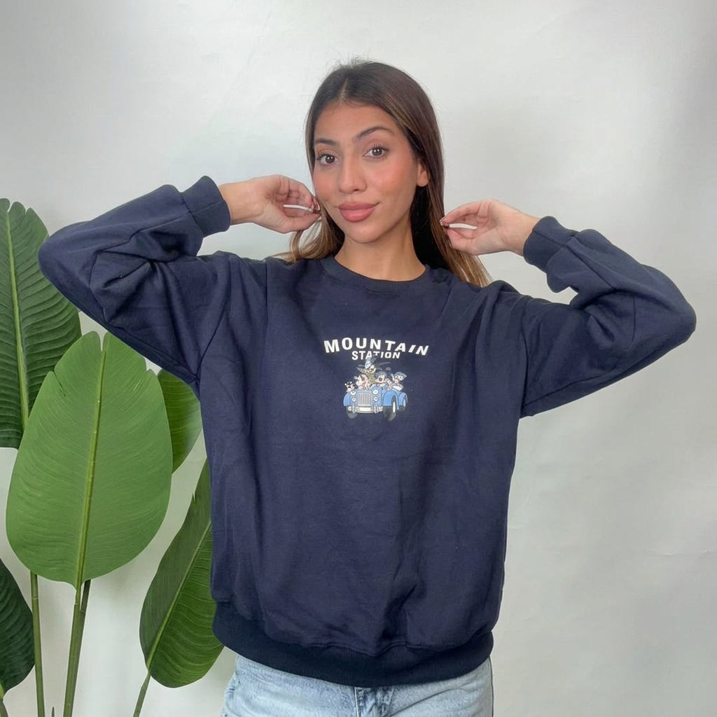 Navy Mountain Station sweatshirt worn with hands raised, showing the relaxed dropped shoulders