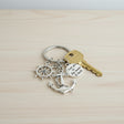 Navy keychain with anchor, ship wheel, and a to the moon and back disc charm