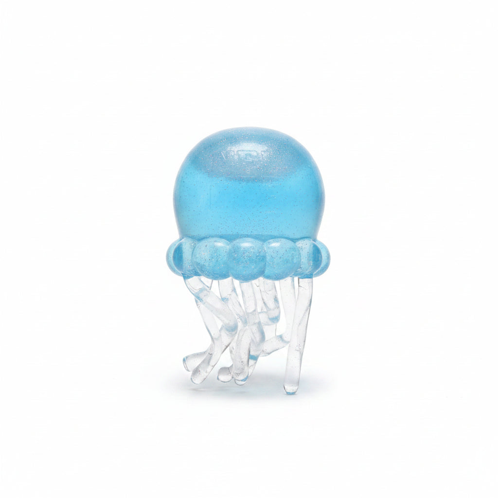 Blue glitter jellyfish squish toy with clear tentacles standing unboxed on a white background