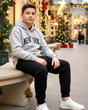 Grey New York hoodie with black joggers worn at a Christmas market