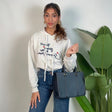Oatmeal marl cropped hoodie with navy script embroidery worn with blue jeans