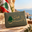 Handmade olive green pouch with gold Arabic I love you Lebanon embroidery and a green cedar, with the Lebanese flag behind