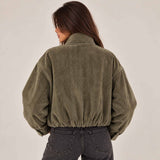 Back view of an olive herringbone jacket with gathered elastic hem