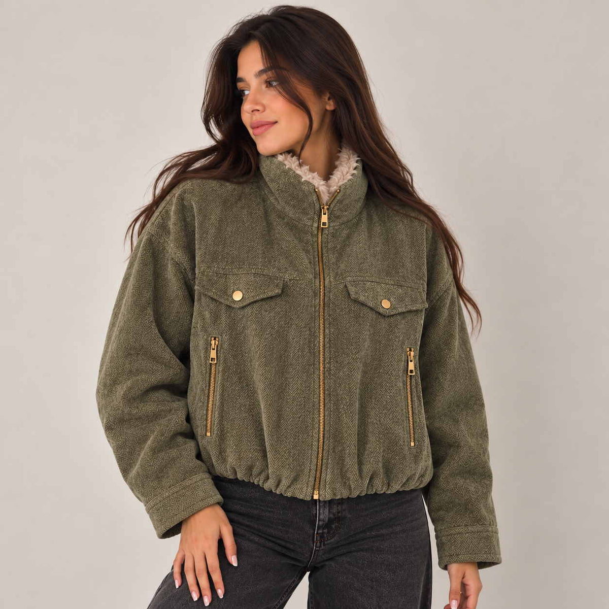 Olive herringbone bomber jacket zipped up with sherpa trim at the collar