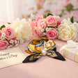 Orange and gold print foulard with a pearl among pink roses