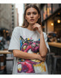 Woman wearing a white tshirt with a colorful graphic design in an urban setting
