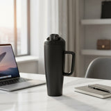 Matte black insulated tumbler with the flip cap open and steam rising