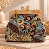 Front view of a multicolour paisley tapestry bag with a wooden frame, marbled cube clasp and gold chain