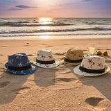 Four kids palm print straw fedora sun hats in navy, white, tan and beige lined up on sand