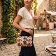 Handmade patchwork bag in rust, sage and cream squares worn crossbody on a gold chain