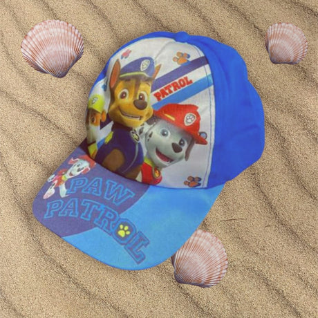 Blue and white three pup cap placed on sand between seashells
