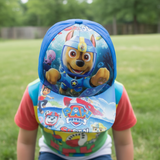 Blue kids cap with a scuba pup diving underwater, held up outdoors on grass