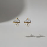 Pair of earrings with pearl-like centers on a light grey background