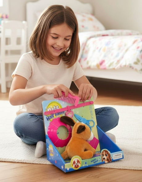 Open salon box with a plush puppy, a magenta grooming cape, toy scissors and a comb