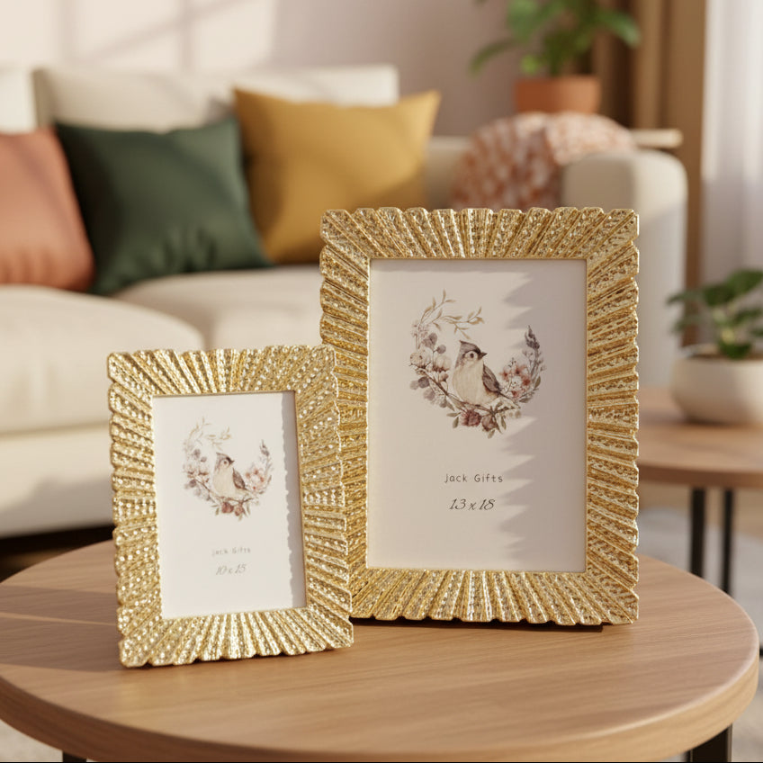 Two gold frames with deep fluted sunburst borders on a round oak side table