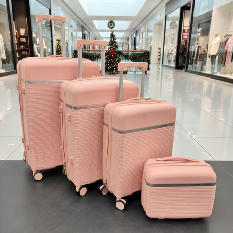 Four pink suitcases lined up by size on a polished mall floor