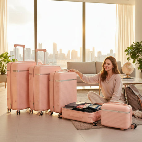 Blush pink hard shell luggage set of four with a vanity case