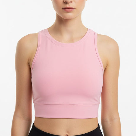 Woman wearing a pink crop top against a white background