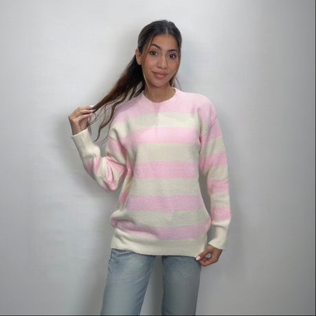 Close view of a pastel pink and cream striped knit sweater with long sleeves