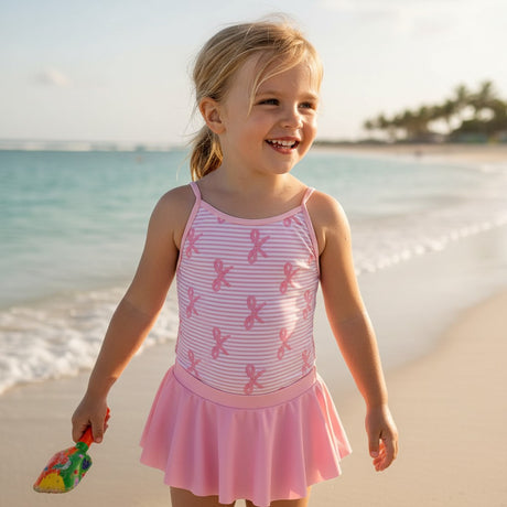 Pink bow stripe skirted swimsuit worn on the beach, Jack Gifts Online Lebanon