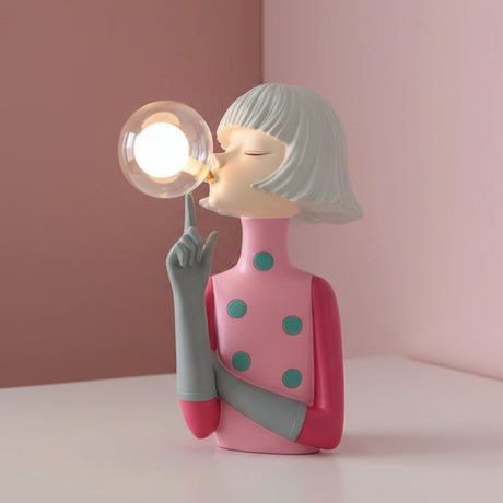 Soft pink dress with teal spots, silver bob and one finger raised beside a lit globe