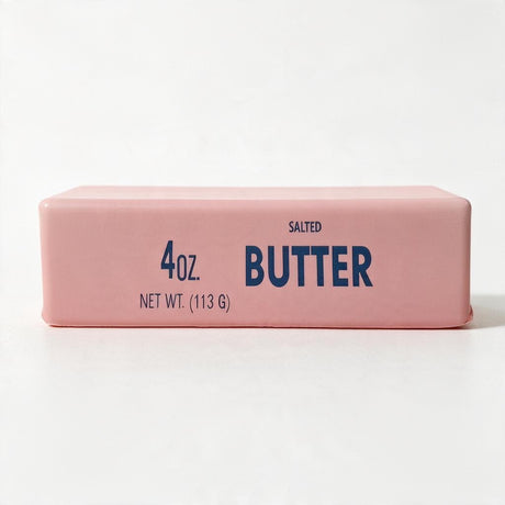 Pink butter stick squishy printed with Salted Butter and 4 oz in blue