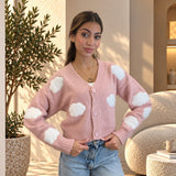 Pink V neck knit cardigan with fluffy white cloud appliques, buttoned