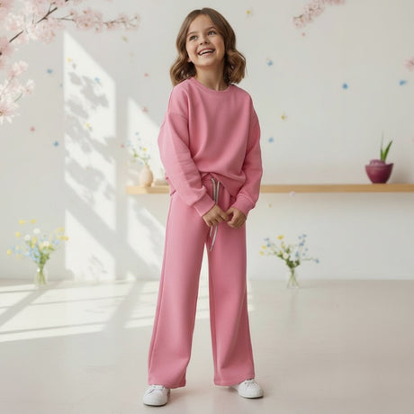 Girl in a pink sweatshirt and matching wide leg jogging pants