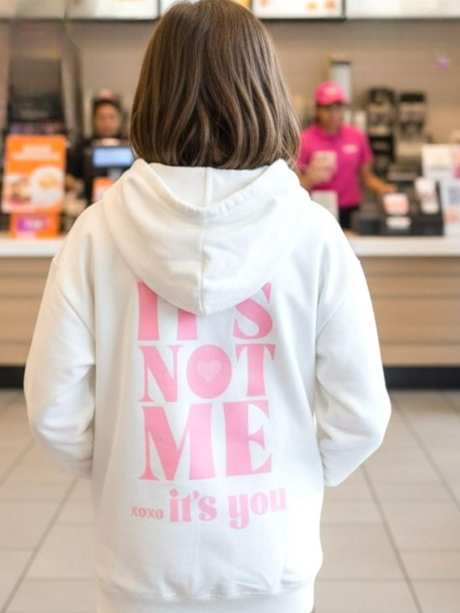 Cream hoodie with pink chest print and matching pink joggers