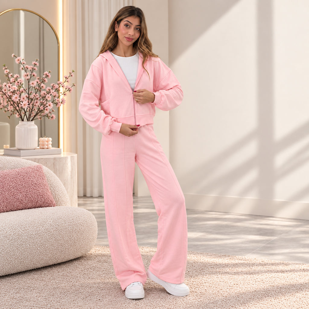 Pink cotton zip hoodie worn half zipped over a white tee with matching seam front wide leg pants