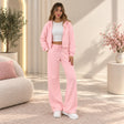 Woman in a pink cropped zip hoodie and wide leg pants set with a white crop top and sneakers