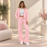 Woman in a pink cropped zip hoodie and wide leg pants set with a white crop top and sneakers
