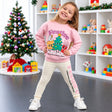 Girl in a pink Festive Friends Christmas sweatshirt and cream printed leggings by a tree