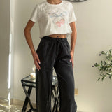 Pink floral crop tee tied at the waist with charcoal drawstring trousers