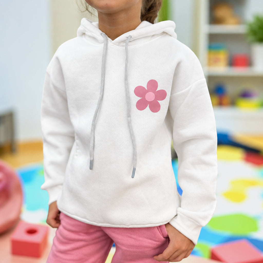 Close view of the pink daisy motif on the white hoodie with pink jogger bottoms
