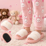 Girl wearing pink fluffy slide slippers with a cream faux fur strap, with close ups of the strap and black grip sole
