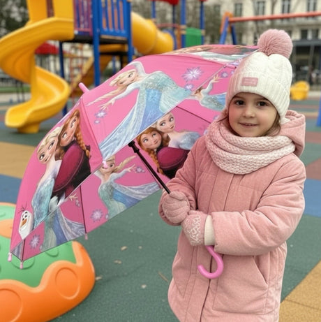 Girl at a playground holding an open pink Frozen kids umbrella with Elsa