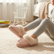 Girl wearing dusty pink kids slippers with a faux fur collar, Jack Gifts Online Lebanon