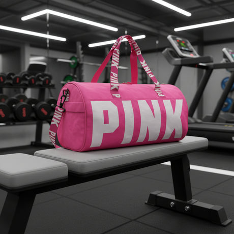 Bright pink gym duffle bag with bold logo print, top handles and adjustable shoulder strap