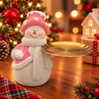 Snowman figurine in a pink frosted top hat and scarf holding a round golden tray