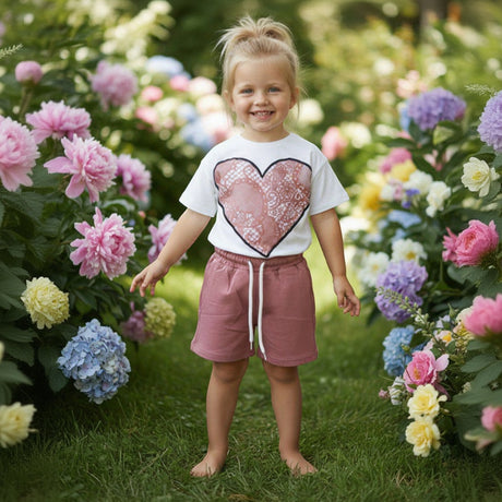 Girl in a white lace heart print tee and dusty rose shorts