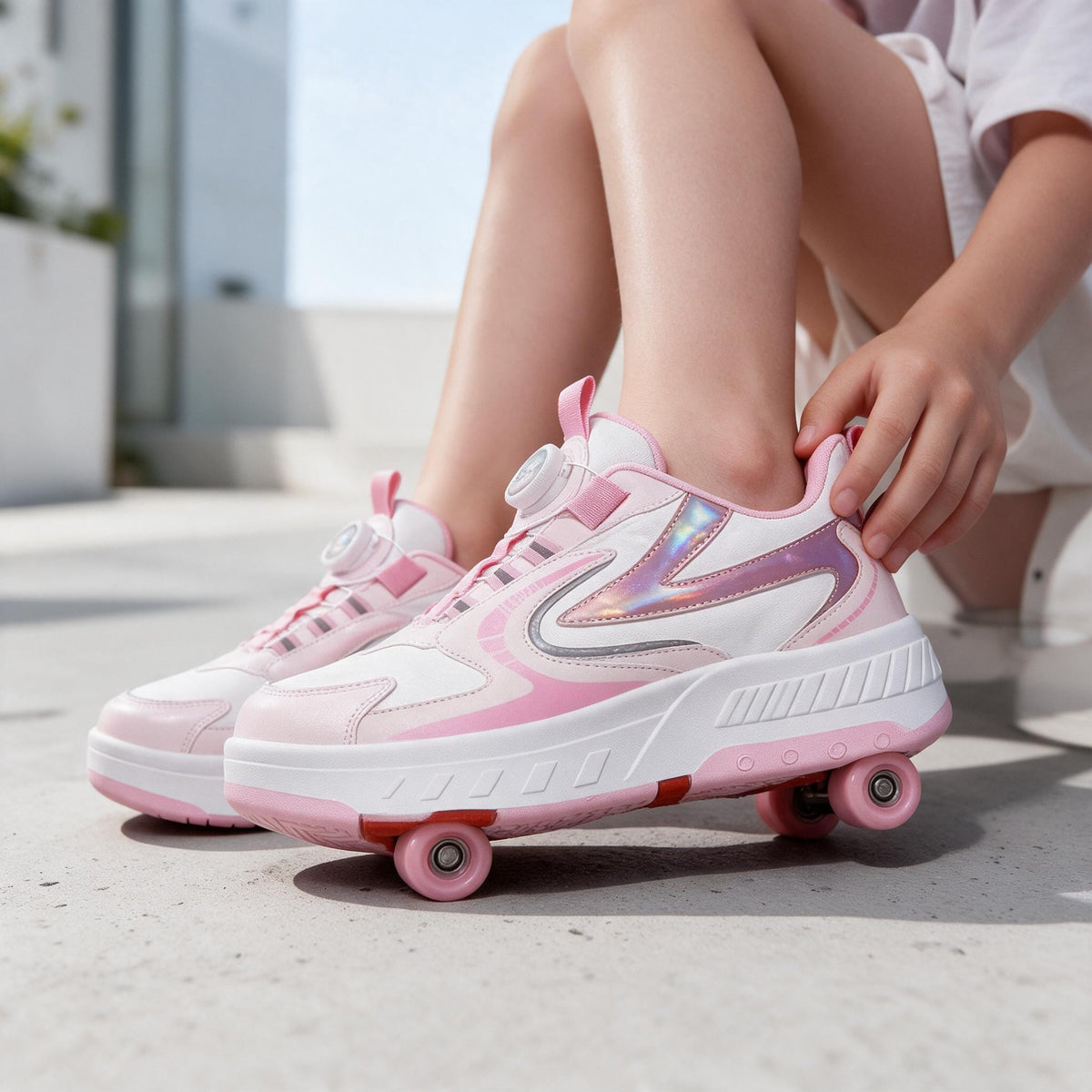 Pink and white roller shoes with a twist dial and holographic side panel, worn outdoors on concrete