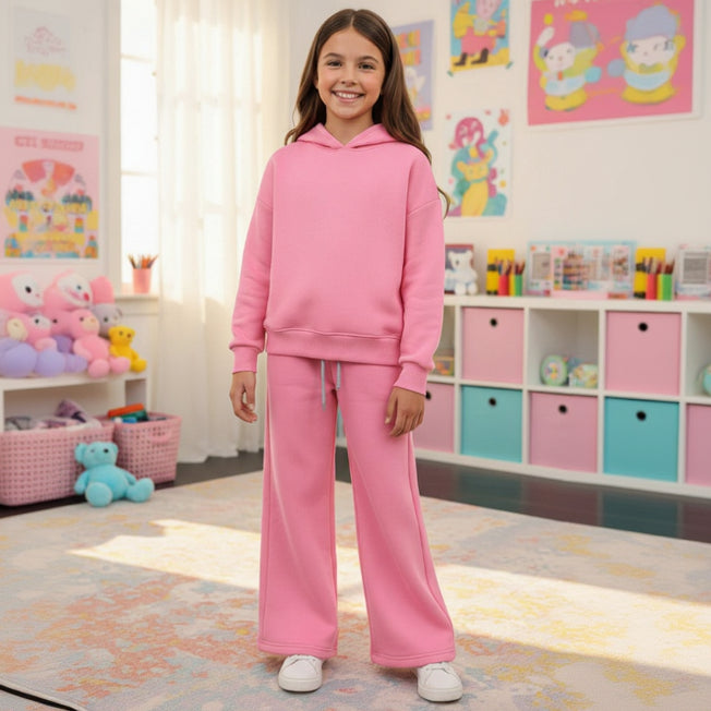 Girl in a pink fleece hoodie and matching wide leg joggers