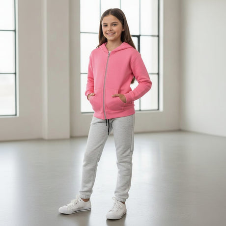 Girl in a pink zip up hoodie and grey cuffed joggers