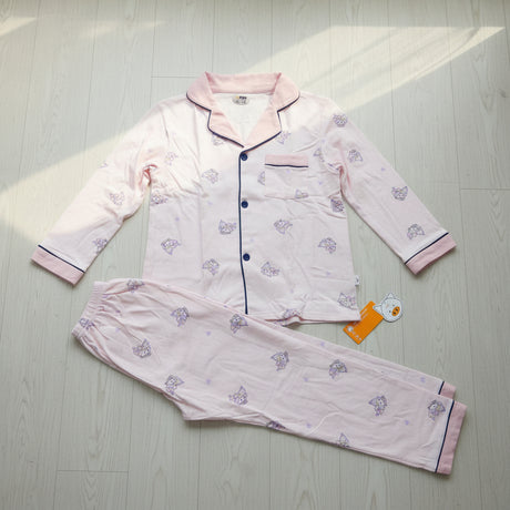 Pale pink cartoon print button front kids pyjama set laid flat, long sleeve top with matching pants
