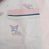 Chest pocket close up on a pink kids pyjama top with navy piping and a cartoon character print